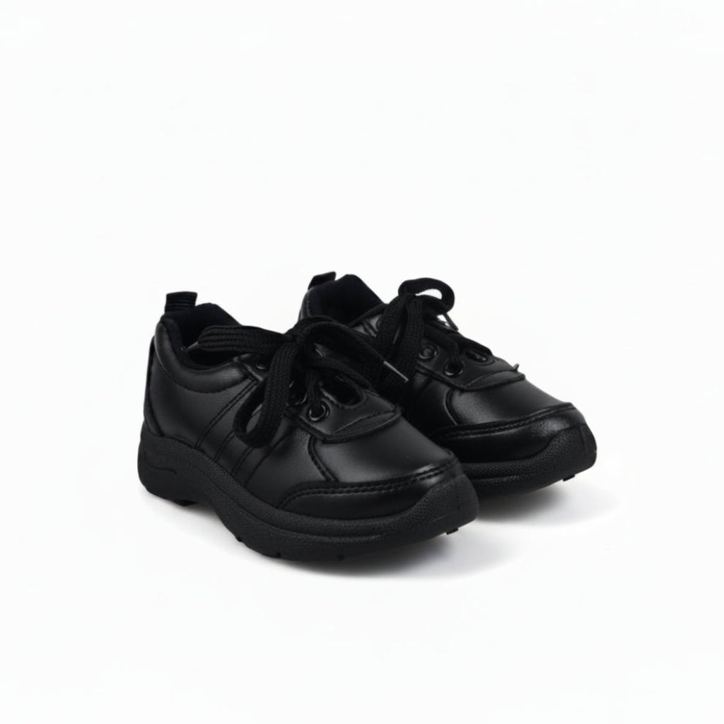 A pair of black low-top lace-up shoes with black soles, photographed on a plain white studio background.