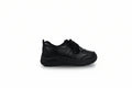 A single black low-top casual sneaker with a thick black sole, shown from a side profile against a light gray studio background.