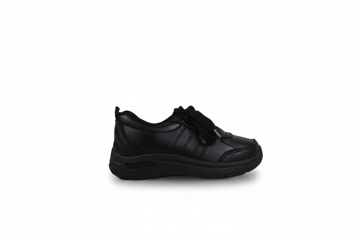A single black low-top casual sneaker with a thick black sole, shown from a side profile against a light gray studio background.