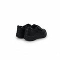 A pair of black slip-on sneakers shown from the back and side against a plain white studio background.