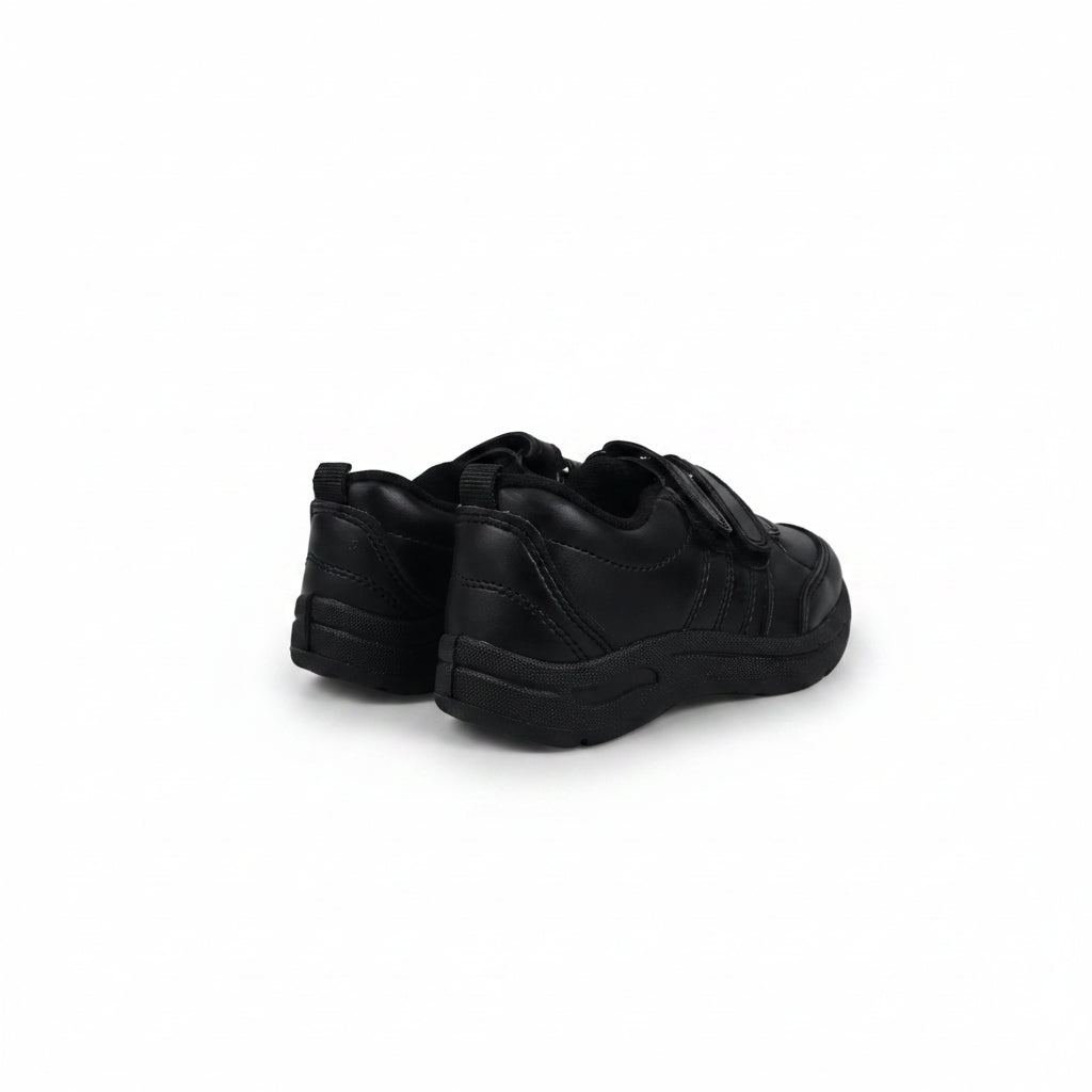 A pair of black slip-on sneakers shown from the back and side against a plain white studio background.