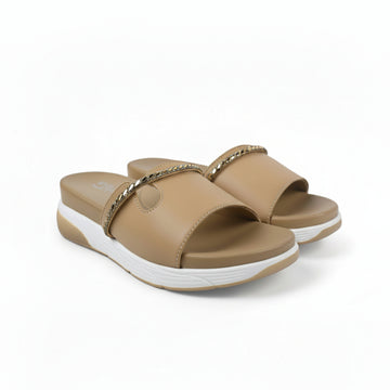 A pair of women's slide sandals in tan with a gold-tone chain detail across the top and a white sole, shown against a light gray background.