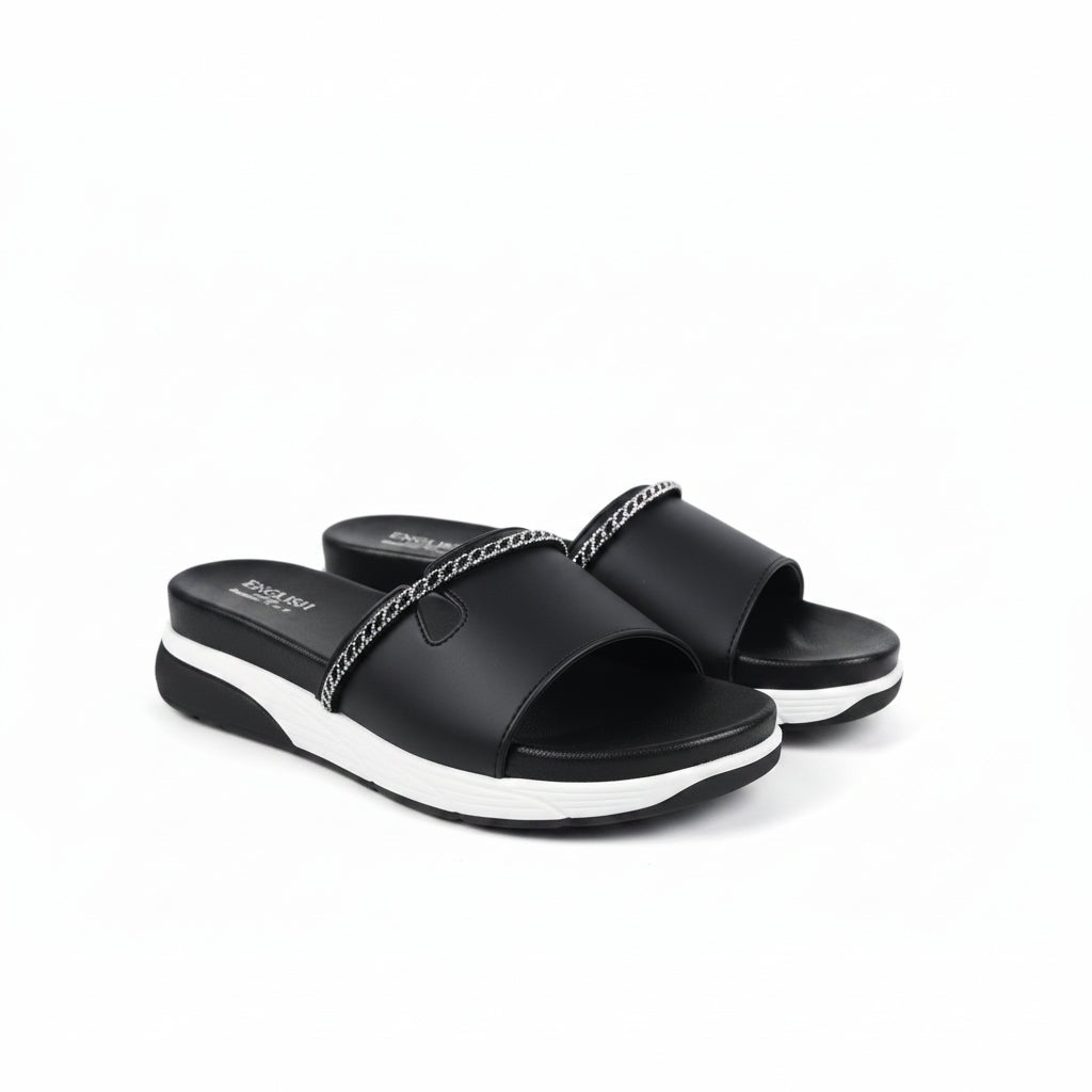 A pair of black slide sandals with white platform soles and a silver chain detail across the top, displayed on a light gray background.