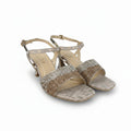 A pair of women's heeled sandals with glittery metallic gold straps and a snakeskin-patterned toe strap, shown on a white background.