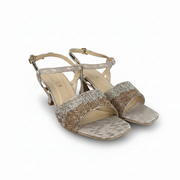 A pair of women's heeled sandals with glittery metallic gold straps and a snakeskin-patterned toe strap, shown on a white background.