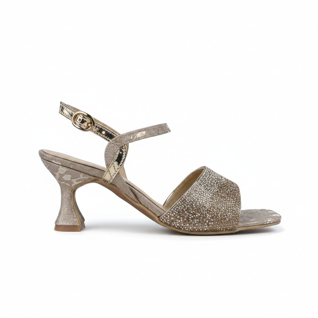 A single women's heeled sandal with a metallic gold and silver rhinestone-embellished toe strap, a textured metallic gold heel, and a slim ankle strap with a buckle, shown against a plain light gray background.