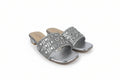 A pair of women's silver slide sandals with geometric rhinestone embellishments on the straps, set against a plain white background.