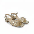 A pair of women's metallic gold block-heel sandals with square toes, featuring decorative rhinestone-embellished straps and an ankle buckle, shown on a white background.