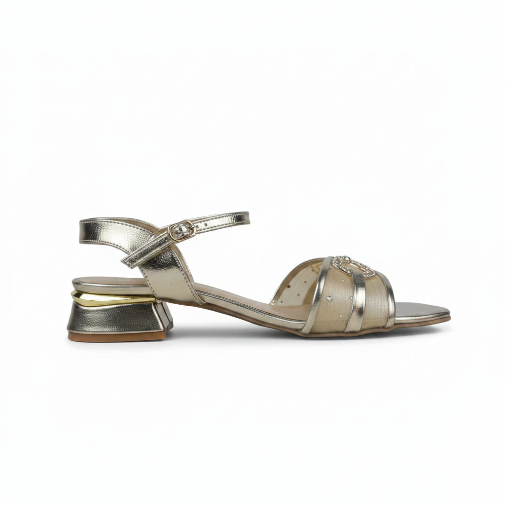 A metallic gold heeled sandal with an ankle strap and a square toe, shown from a side profile against a light gray background.