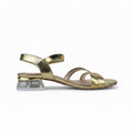 A single metallic gold strappy sandal with a clear acrylic block heel, shown from a side profile on a white background.