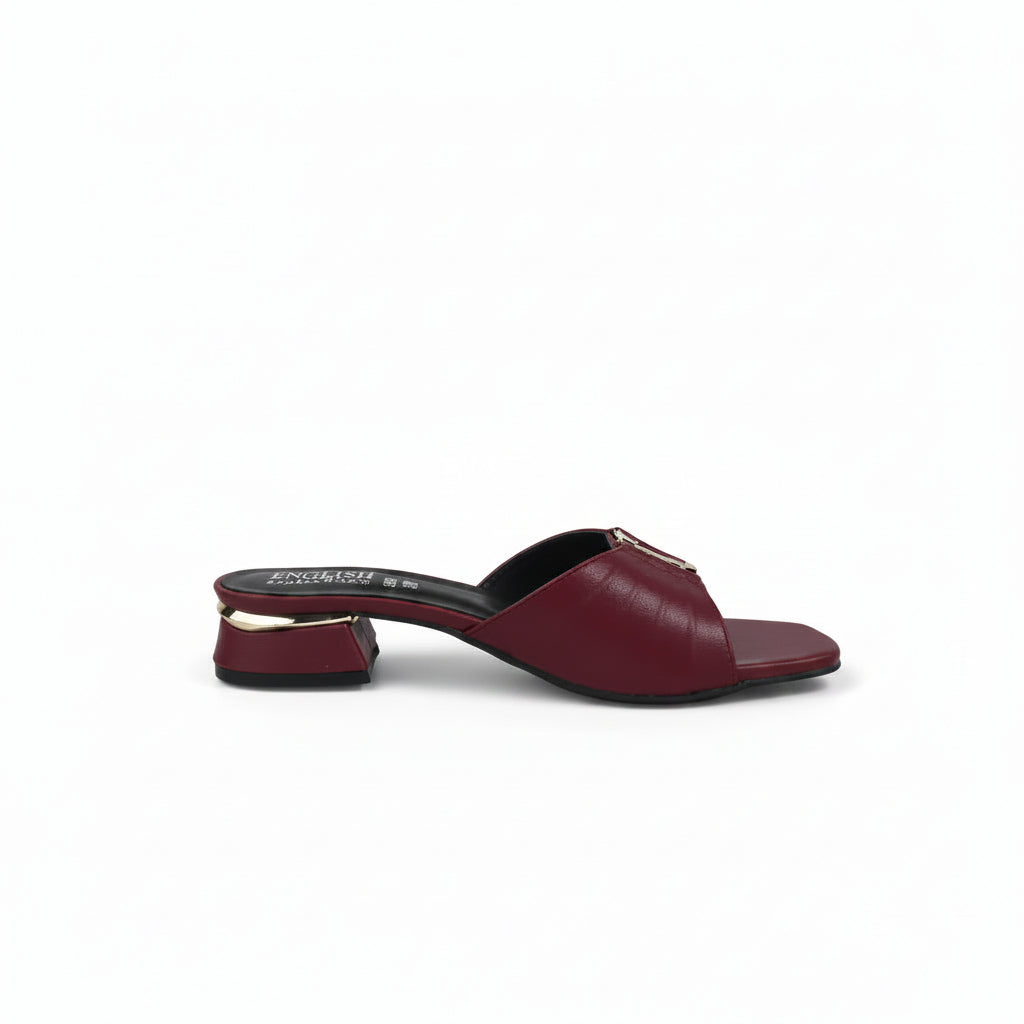 A single burgundy leather mule sandal with a low block heel and a gold-tone metal accent on the strap, shown from a side profile against a light gray background.