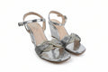 A pair of women's metallic silver wedge sandals with ankle straps, rhinestone-embellished toe straps, and a knotted bow detail on the front, shown on a white studio background.