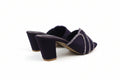 A pair of women's heeled mule sandals in deep purple velvet, featuring a pointed toe embellished with silver rhinestone straps and a chunky block heel.