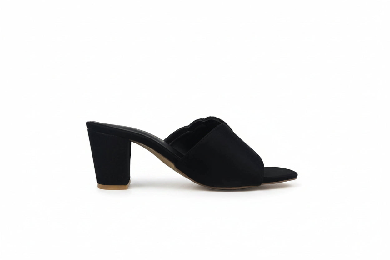 A single black mule sandal with a block heel and open toe, shown from a side profile against a light gray background.