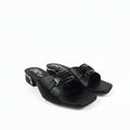 A pair of black leather slide sandals with square toes and double buckle straps, featuring a low block heel and gold-tone hardware, photographed on a light gray background.