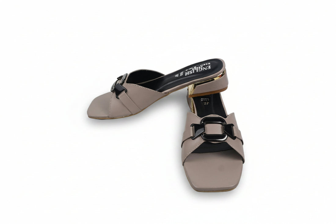 A pair of black leather slide sandals with square toes and double buckle straps, featuring a low block heel and gold-tone hardware, photographed on a light gray background.