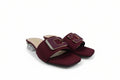 A pair of burgundy slide sandals with a chunky block heel and a large decorative buckle strap embellished with rhinestones, set against a plain white background.