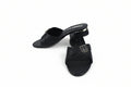 A pair of black leather slide sandals with textured straps and a block heel, featuring a gold-tone buckle detail on the strap and the brand name 'MARC SCALPR' printed on the insole.