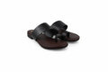 A pair of women's minimalist slide sandals in dark brown leather, featuring wide upper straps and a thong toe, displayed on a white studio background.