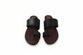 A pair of men's minimalist slide sandals with wide black straps and dark brown footbeds, displayed on a light gray background.