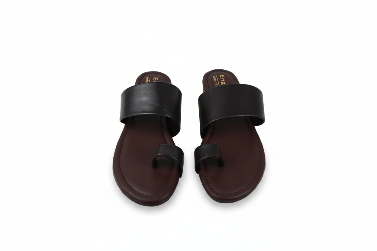 A pair of men's minimalist slide sandals with wide black straps and dark brown footbeds, displayed on a light gray background.