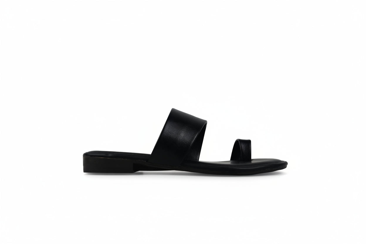 A single black leather slide sandal with a wide strap and a small toe loop, shown in profile against a light gray background.