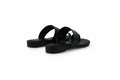 A pair of black leather slide sandals with wide double straps and low stacked platform soles, shown on a light gray background.