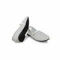 A pair of white woven slip-on shoes with black soles and a small gold buckle detail, displayed on a light gray studio background.