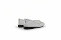 A pair of white woven leather ballet flats with perforated details and black soles, shown from a side-rear angle on a light gray studio background.