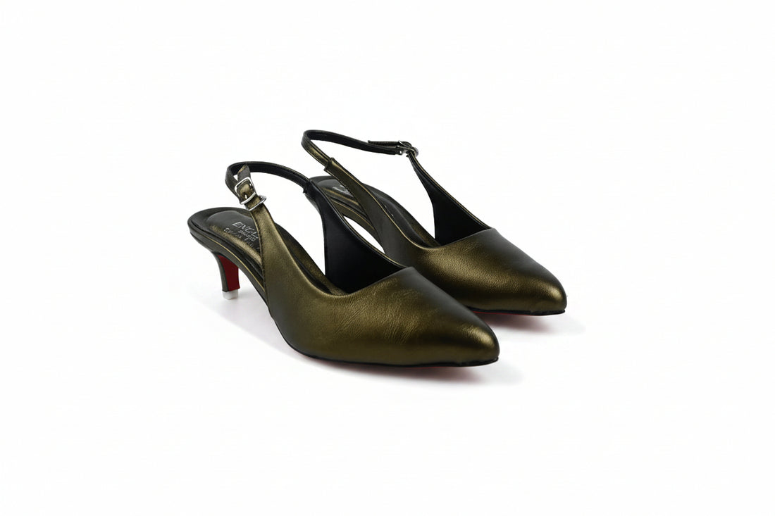 A single light beige leather slingback pump with a pointed toe and kitten heel, featuring a small gold buckle on the ankle strap and a red sole, shown against a neutral light gray background.