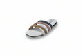 A single women's slide sandal with a white footbed and three horizontal straps in white, navy blue, dusty pink, and tan, photographed on a light gray studio background.