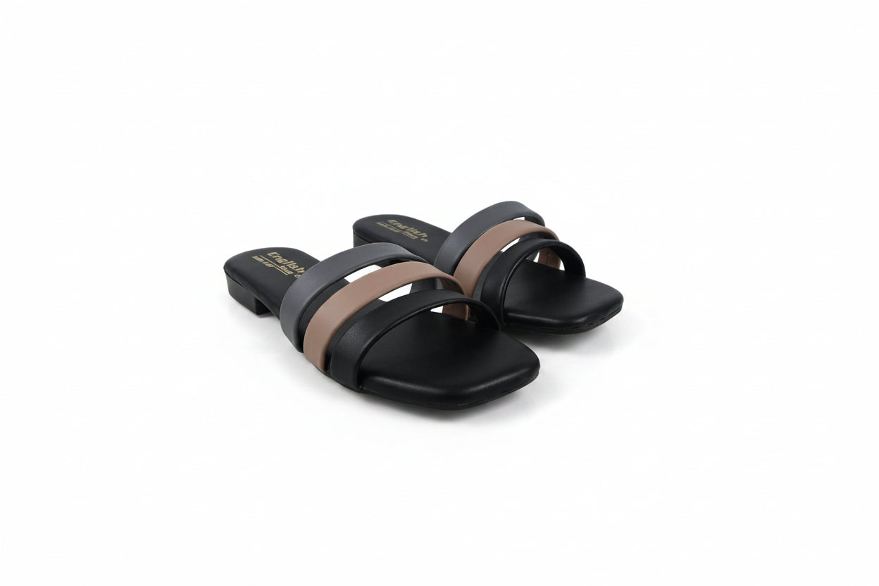 A pair of black slide sandals with two wide straps, one in black and one in taupe brown, featuring gold lettering on the insole.