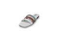 A white flat slide sandal with three horizontal straps in sage green, brown, and white, featuring a low block heel and a small gold logo on the side.
