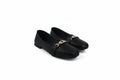 A pair of black leather loafers with a gold-tone metal chain detail across the vamp, displayed on a white studio background.
