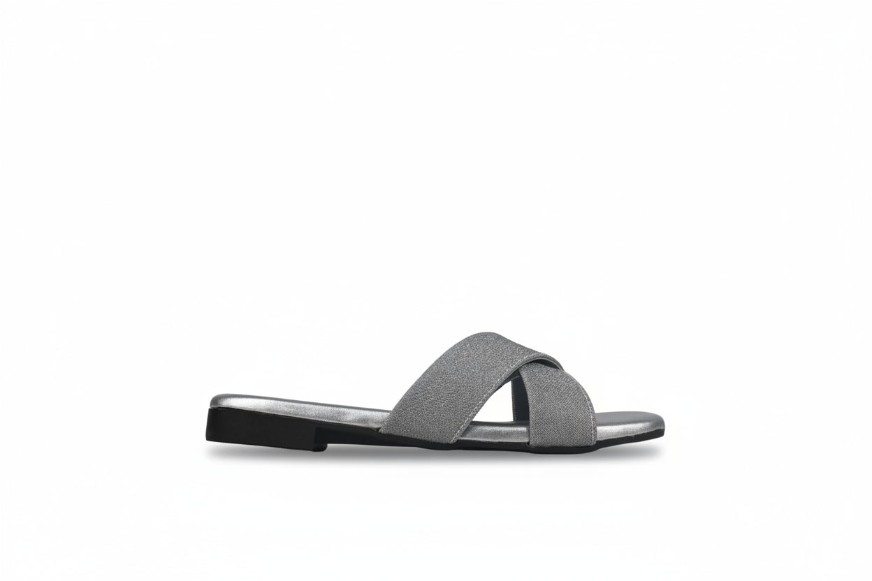 A single flat slide sandal with two wide, textured gray straps and a black sole, shown from the side against a neutral gray background.