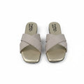 A pair of women's slide sandals with metallic gold square toes and crisscrossing beige straps, shown on a light gray background.