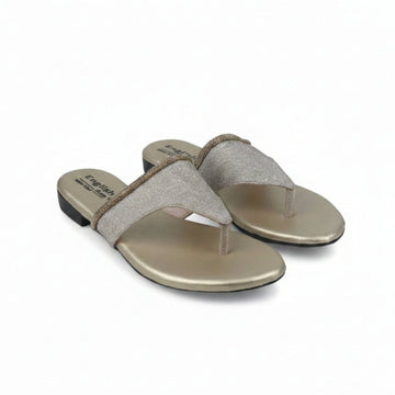 A pair of women's thong sandals with metallic gold flat feet and glittery beige straps, shown on a white studio background.