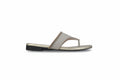 A single women's thong sandal in a light beige or taupe color with a metallic gold trim, shown in a side profile against a light gray background.