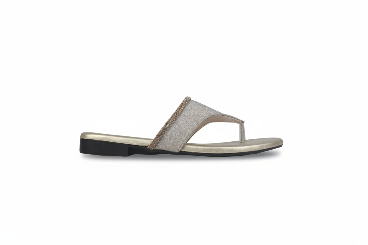 A single women's thong sandal in a light beige or taupe color with a metallic gold trim, shown in a side profile against a light gray background.
