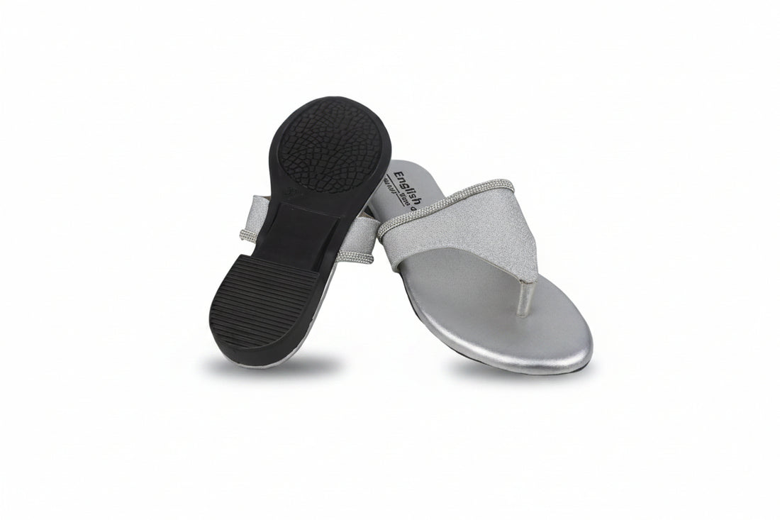 A pair of women's thong sandals with metallic gold flat feet and glittery beige straps, shown on a white studio background.