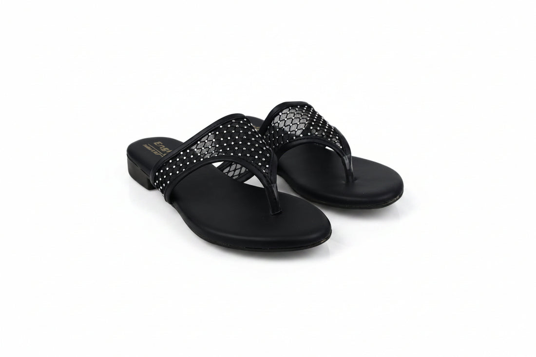 A pair of black slide sandals with rhinestone-embellished straps, photographed on a light gray studio background.