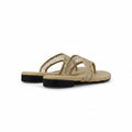 A pair of beige woven thong sandals with black soles, shown from a side profile view on a light gray background.