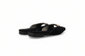 A pair of black pointed-toe flat mule sandals with thin straps and small gold-tone hardware, photographed on a light gray studio background.
