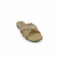 A single beige slide sandal with a textured, woven pattern across the upper strap, photographed on a light gray floor against a matching backdrop.