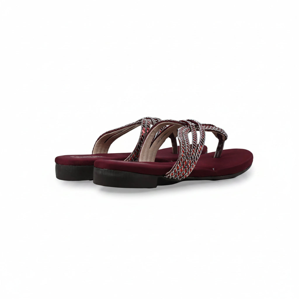 A pair of women's flat thong sandals with burgundy red soles and straps, featuring a woven multicolor pattern detail on the straps, set against a plain light gray background.