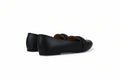 A pair of black leather penny loafers shown from the side against a plain white studio background.