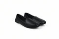 A pair of black leather slip-on loafers with square toes, displayed on a light gray studio background.