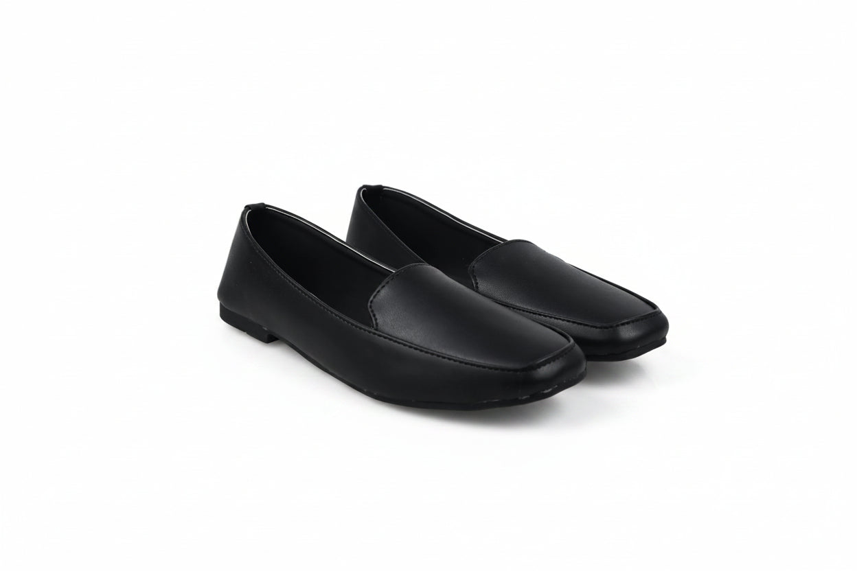 A pair of black leather slip-on loafers with square toes, displayed on a light gray studio background.