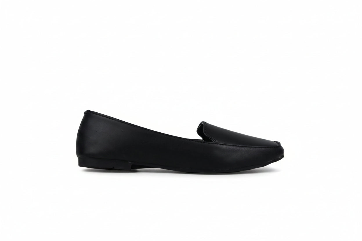 A single black leather loafer flat shoe shown in profile against a light gray textured background.