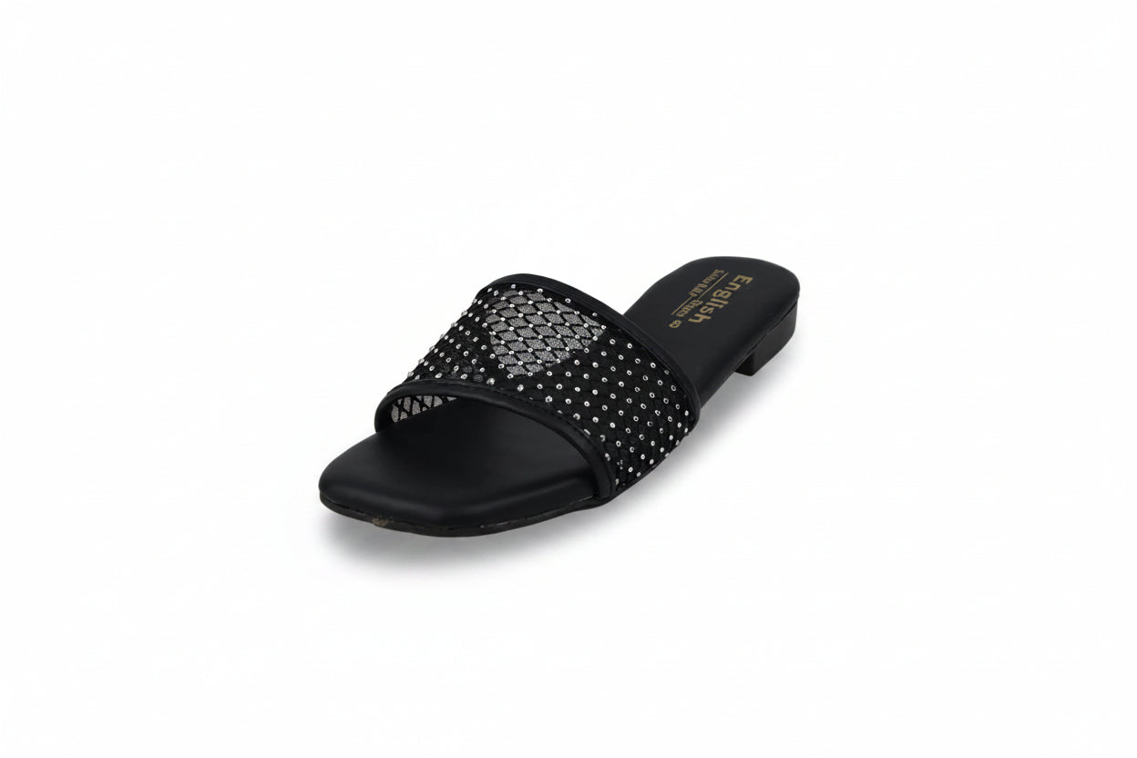 A single black slide sandal with a wide strap embellished with silver rhinestones, shown on a light gray background.